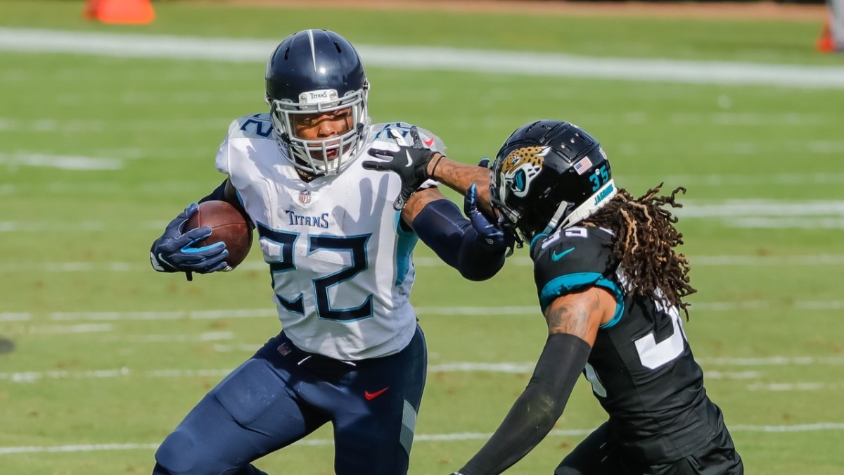Henry runs the ball around Jacksonville Jaguars cornerback Sidney Jones. 